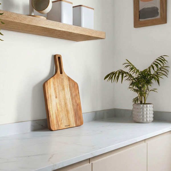 Rectangular wooden chopping board on marble kitchen counter