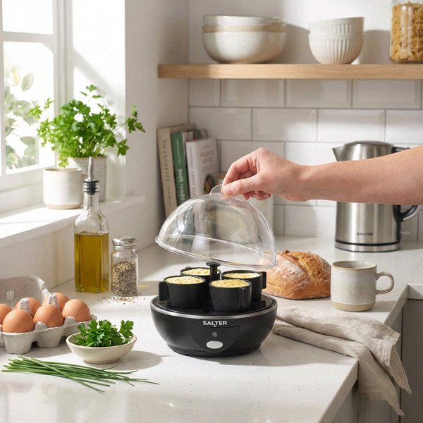 Salter egg cooker with four egg cups in a kitchen, hand lifting lid