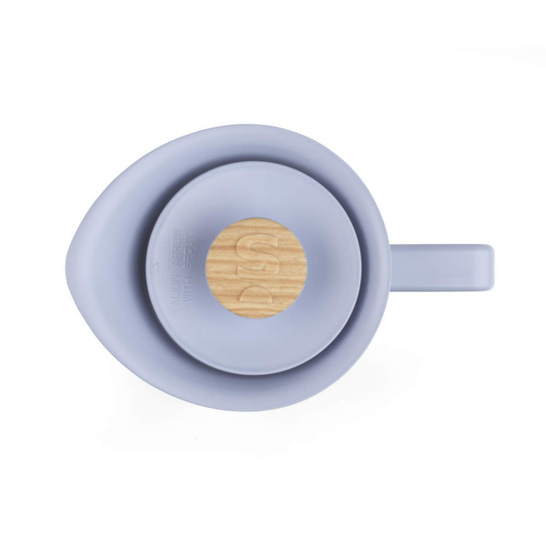 Blue silicone and wood teapot lid viewed from above, showing handle and spout alignment.