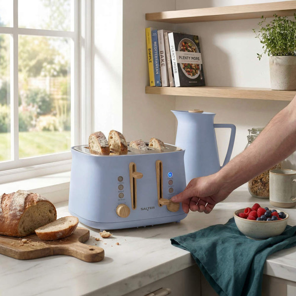 Blue four-slice toaster with bread, wooden controls, used in modern kitchen setting