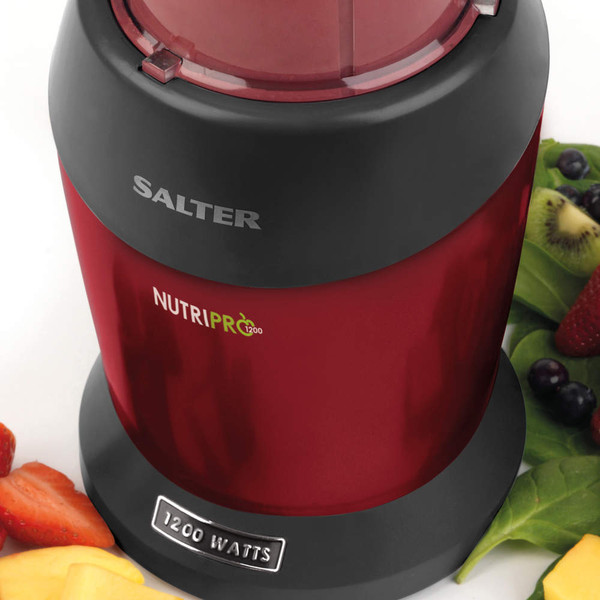 Red Salter NutriPro 1200W blender base with fruit and leafy greens beside it