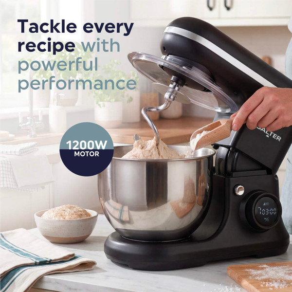 Black stand mixer with beater, mixing flour, butter and eggs in a kitchen setting
