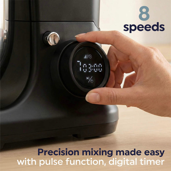 Hand turning digital speed dial on black food mixer, showing timer and settings.