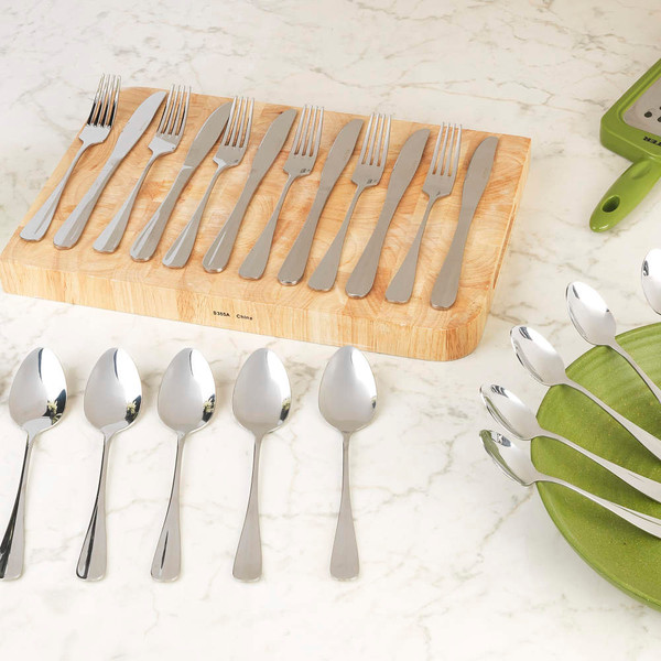 Stainless steel cutlery set with spoons, forks, and knives displayed on table.