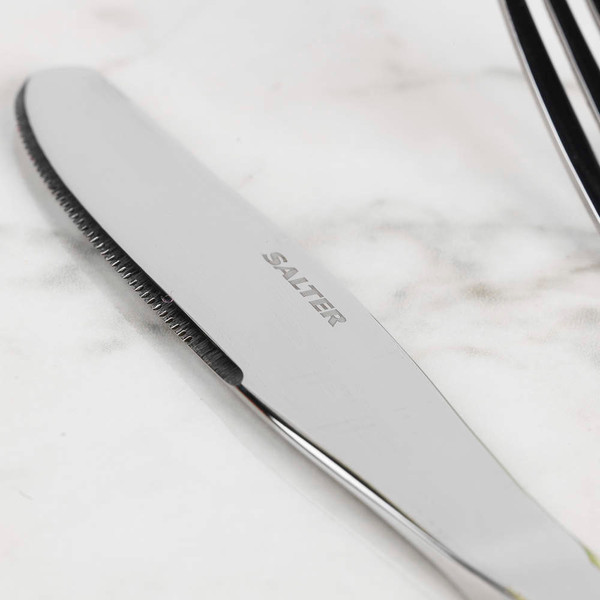 Stainless steel dessert spoon, polished, shown upright on white background