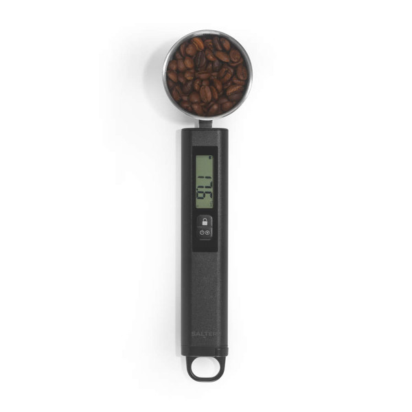 Digital coffee scoop scale with display, filled with coffee beans on white background