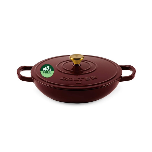Red casserole dish with lid, gold handle and PFAS free label, shown from above.