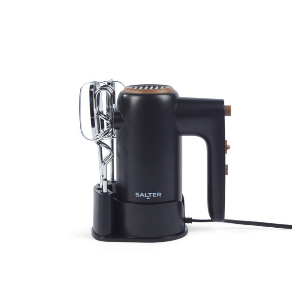 Black electric hand mixer with wood accents and two beaters on stand