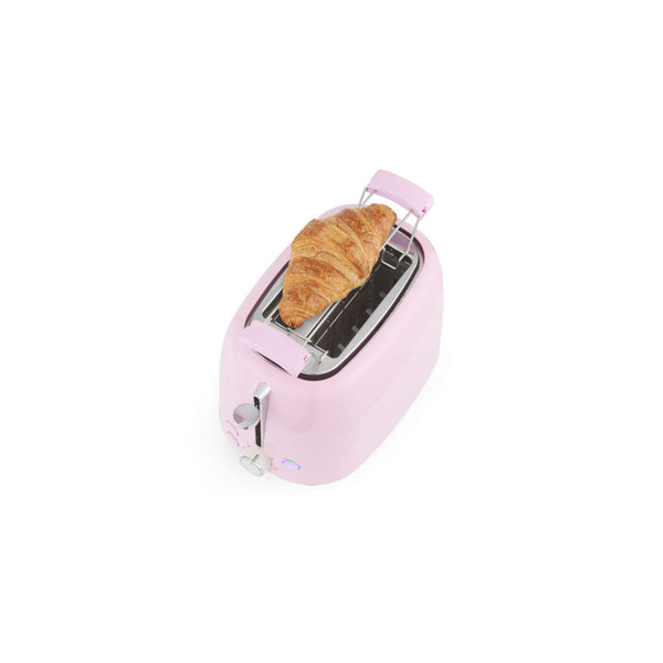 Pink toaster with croissant on warming rack, shown from above
