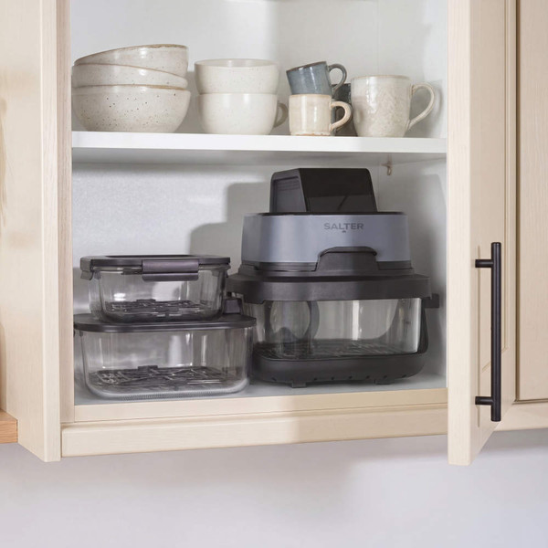 Air fryer and glass food containers stored in kitchen cupboard