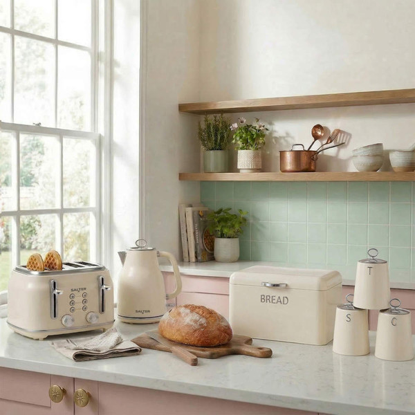 Cream kettle and toaster set with bread box and jars on kitchen counter