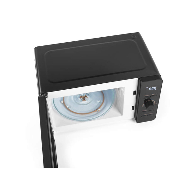 Top view of black microwave with open door, showing glass turntable and digital control panel