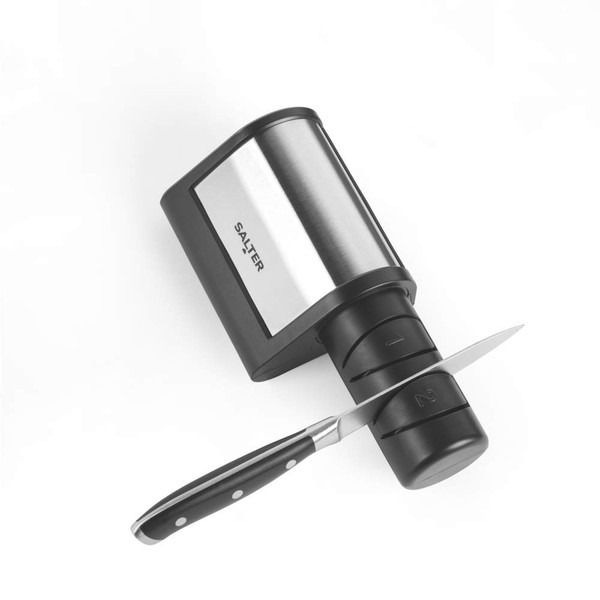 Electric knife sharpener in black with a stainless steel panel, shown sharpening a knife