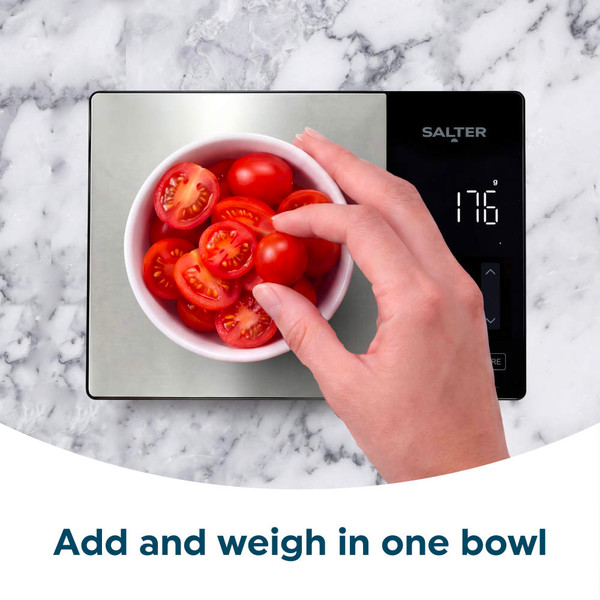 Silver digital kitchen scale weighing a bowl of cherry tomatoes