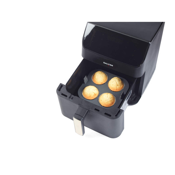 Black air fryer with four baked cupcakes in tray, product showing food capacity