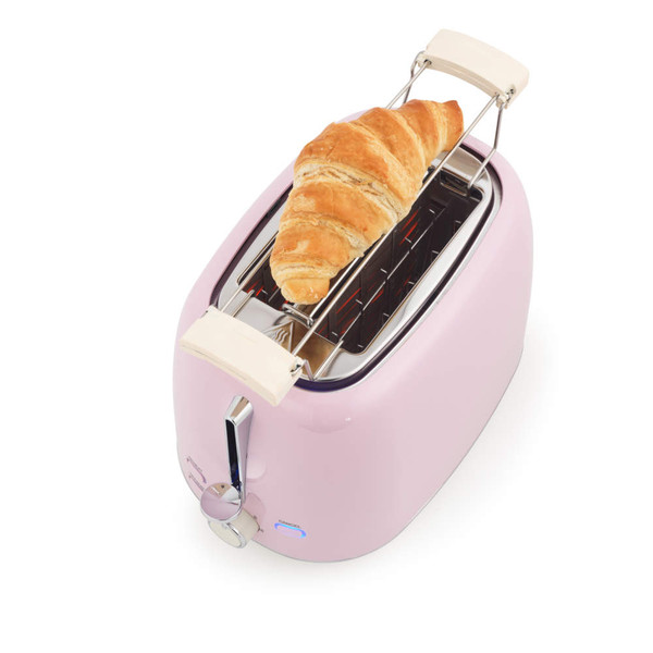 Pink toaster with warming rack heating a croissant, shown from above