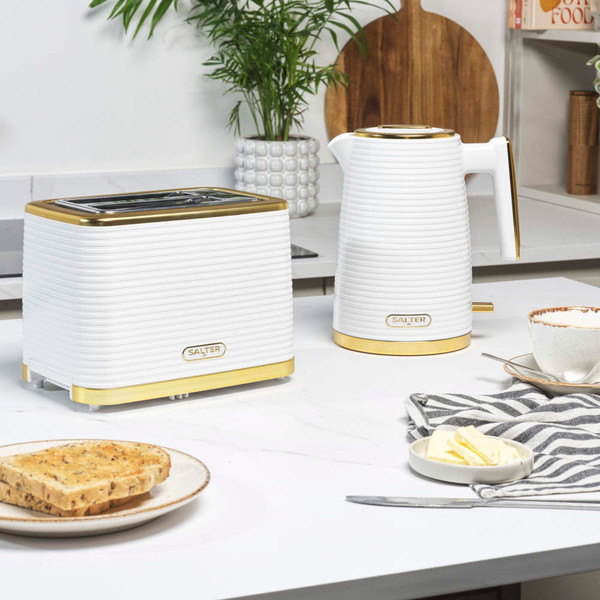 White and gold electric kettle on kitchen worktop, modern ribbed design