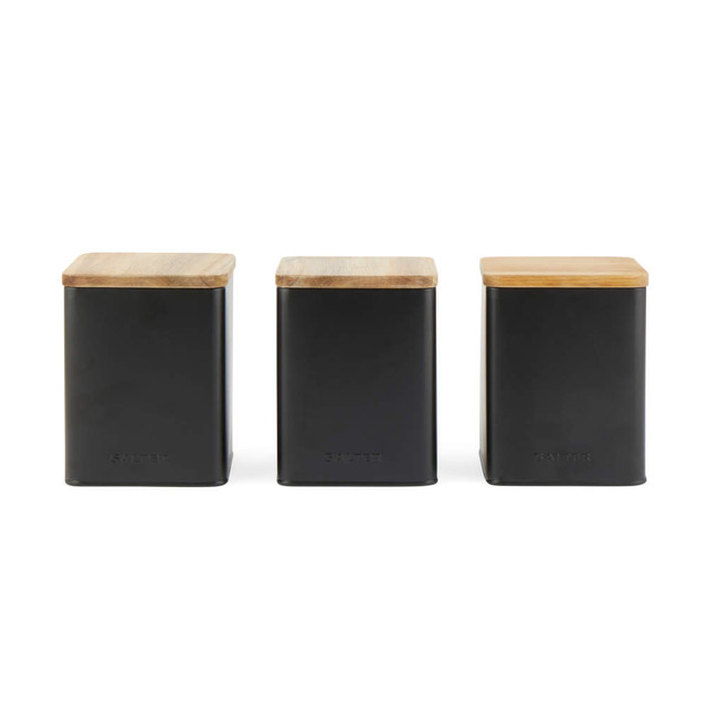 Set of three black canisters with wooden lids, suitable for tea, coffee, and sugar.