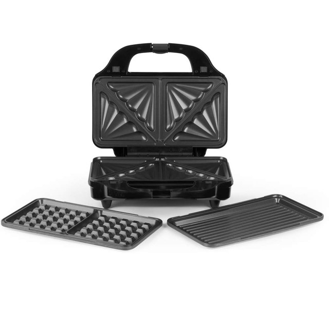 Black sandwich maker with interchangeable grill and waffle plates, open on white background