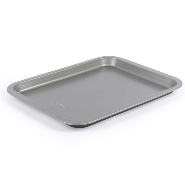Grey non-stick baking tray shown angled on a white background