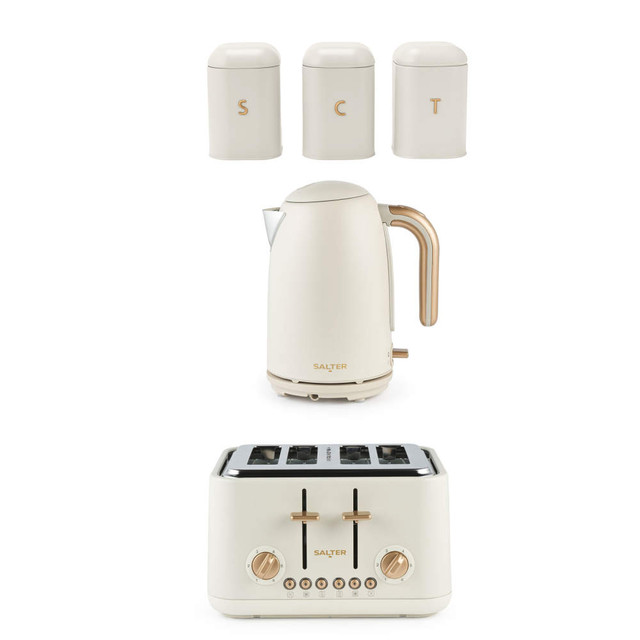 Cream kettle, toaster and canister set with gold accents, pictured on white background