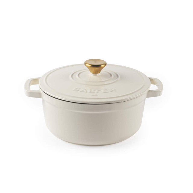 Cream cast iron casserole dish with gold handle and lid, shown from the front.