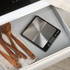 Salter stainless steel digital kitchen scale in a drawer beside wooden utensils