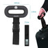 Black digital luggage scale with LCD display, hand shown weighing suitcase. Dimensions visible.