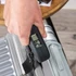 Salter black travel luggage scale on packed suitcase with clothes and sunglasses