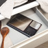Digital kitchen scale with dual stainless steel platforms in open drawer, utensils beside