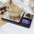 Digital kitchen scale with two platforms, bowl of brown sugar, chocolate pieces, and clear display