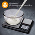 Digital kitchen scale showing milk being poured into a glass bowl, measures liquids in ml or fl oz.