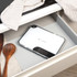 Salter white digital kitchen scale with 5kg capacity, shown with dark chocolate pieces.
