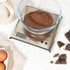 Square silver digital kitchen scale with LCD display, showing 180 grams.