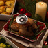 Meat thermometer in roast chicken on red dish, festive dinner setting, UK product image