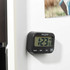 Black Salter digital kitchen timer with three buttons, shown on a fridge door