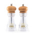Pair of clear acrylic and wood salt and pepper mills on white background
