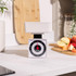 White mechanical kitchen scale with bowl on countertop