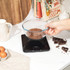 Black Salter digital kitchen scale with red LCD display, shown at zero grams