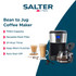 Close-up of hand pressing start button on black and silver filter coffee machine with digital display