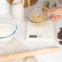 White digital kitchen scale with LCD display and two buttons, front view.