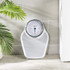 White mechanical bathroom scale with large easy-read dial, shown on tiled floor