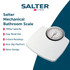 White mechanical bathroom scale with large dial, top-down view.