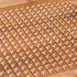 Close-up of brown bamboo chopping board with raised pyramid texture