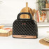 Black sandwich maker with copper detail and bow-shaped emblem, front view