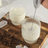 Silver handheld milk frother with whisk and clear protective cover