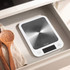 Digital kitchen scale displaying 200 grams with glass bowl of brown sugar