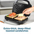 Black sandwich toaster on kitchen counter making toasted sandwiches