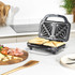 Black sandwich toaster on kitchen counter making toasted sandwiches