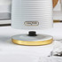 White ribbed electric kettle with gold accents shown on kitchen counter